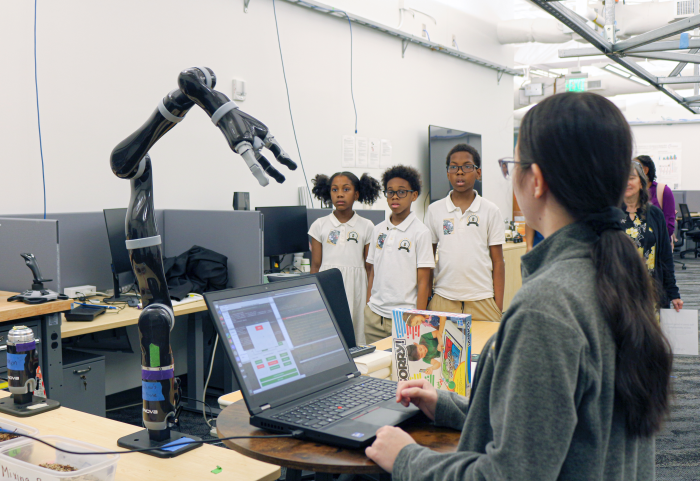 Students touring a robotics lab